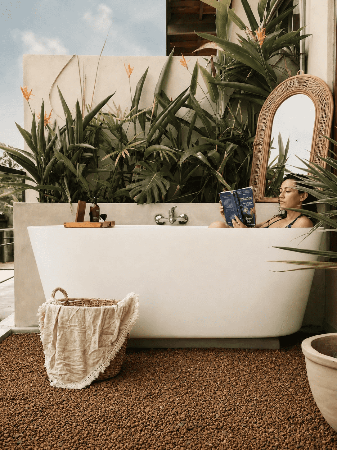 A guest reading in the open-air bathtub at Zen Koggala