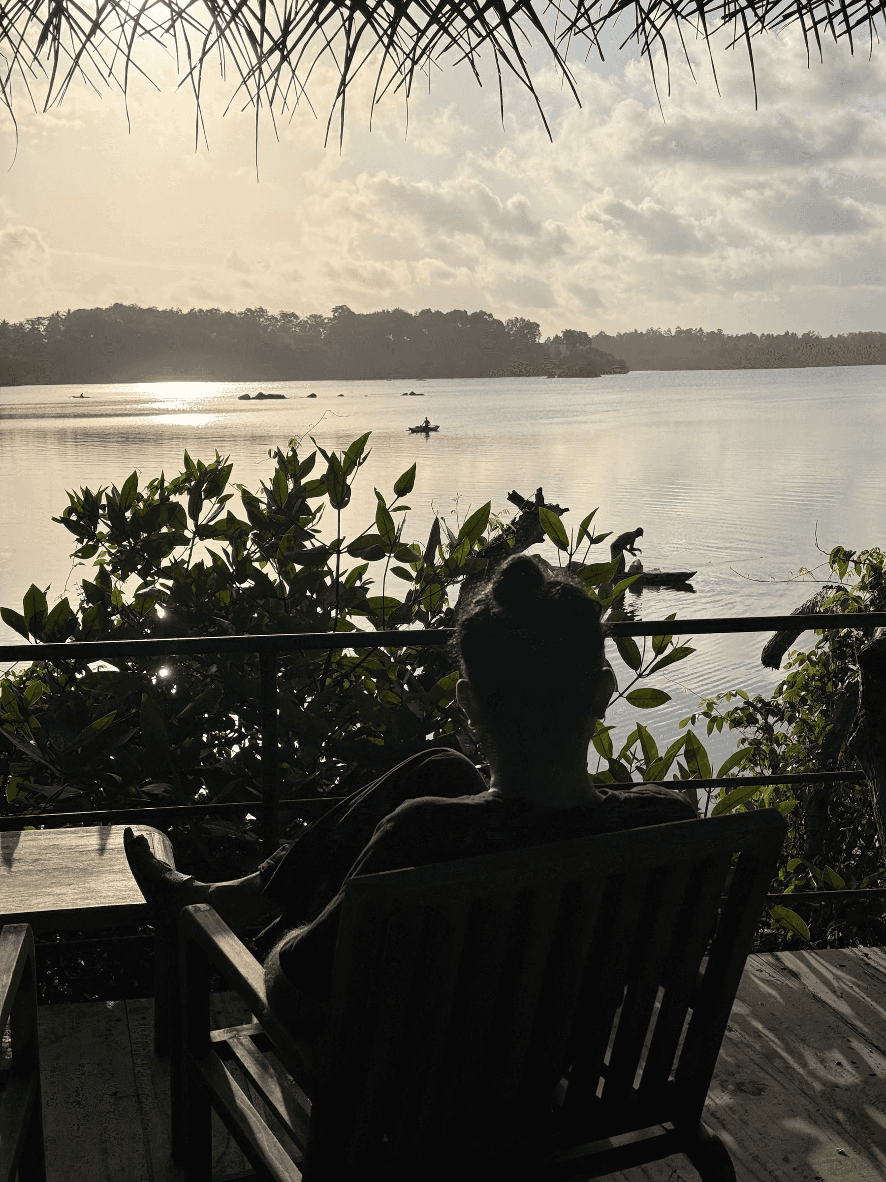 A guest standing on the lake deck at sunrise