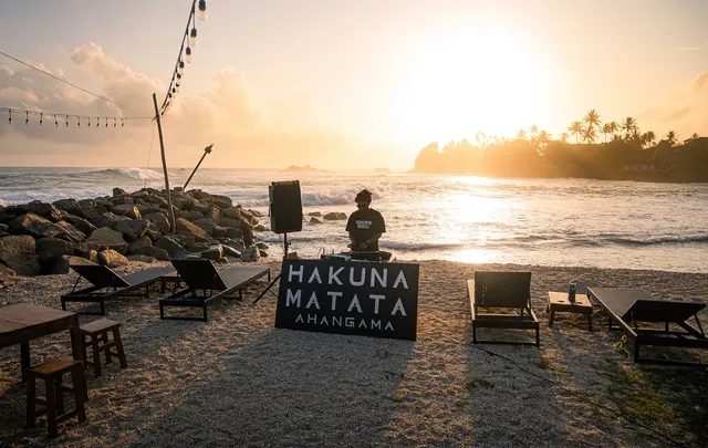 Sunset over the sea at Hakuna Matata in Ahangama, with a DJ setup on the beach